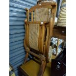 A good example of a Victorian folding steamer chair with caned back and footrest. TO BID ON THIS LOT
