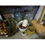 A good collection of vintage advertising bottles and stoneware bottles, two vintage watering cans, a