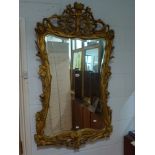 A charming decorative wall mirror of waisted rectangular form within an Art Nouveau frame worked