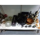 Two shelves of mixed items including a graduated set of four ebony elephants, a pair of