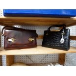 A vintage black alligator Gucci handbag with brass trim, and a brown leather shoulder bag [