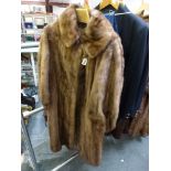 A stylish pastel mink fur full length lady's coat with asymetric fastening, collar, and balloon