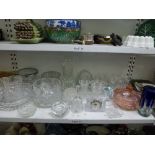 A shelf of glass ware including a matching set of 12 cut glass red and white wine glasses, two