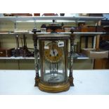 A good French four-glass mantel clock, circa 1900, in oval gilt-metal and champlevé enamel case, the