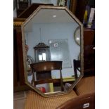 An octagonal wall mirror in a moulded silvered frame. TO BID ON THIS LOT AND FOR VIEWING