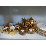 A gold-coloured Royal Worcester part including coffee service including cream jug and sugar bowl,