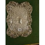 A late Victorian silver dressing table tray embossed and pierced with Union flowers and with