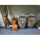 A pair of large floor standing Oriental vases decorated with geishas, a pair of orange glazed