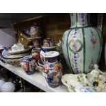 A quantity of Imari pattern china including vases, bowls, ginger jars and covers, plates, etc.,