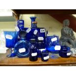 A good collection of blue glass including perfume bottles and stoppers and vases, a clay model of
