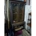 A Victorian oak display cabinet on a carved bookcase base. TO BID ON THIS LOT AND FOR VIEWING