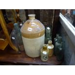 A large stoneware bottle Welugar Colchester, plus further stoneware advertising bottles and