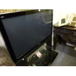 A Panasonic Viera 42 in flat screen television on stand, with remote control TO BID ON THIS LOT