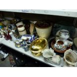 Two shelves of mixed items including planters, a set of 1950s red graduated jugs, a pair of onyx