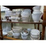 Approximately 45 19th century and later white glazed jelly moulds and a quantity of Lurpak