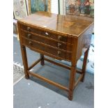 An Art Deco three-drawer walnut table canteen, containing a cutlery service for 12 by Harrison Bros.