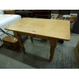 A useful pine kitchen table of rectangular form on turned legs. TO BID ON THIS LOT AND FOR VIEWING