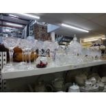 A shelf of glassware including a set of eight Walsh glass champagne glasses plus three similar, a