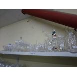A shelf of glassware including a set of eight cut glass hock glasses, wine and sherry glasses, a