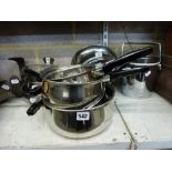 A set of copper-bottomed pans and saucepans with lids and a tiger ice-bucket. [G16] TO BID ON THIS