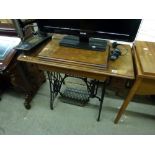 An old trestle-operated Singer Sewing Machine on wrought metal base. TO BID ON THIS LOT AND FOR