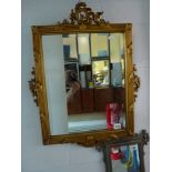 A pretty rectangular gilt mirror with moulded decoration to each sides, 53 x 43 cm plus mouldings.