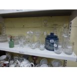 A good shelf of glassware including a blue overlaid glass biscuit barrel depicting a hunting