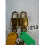 Two small brass padlocks each with keys stamped Louis Vuitton made in France and monogrammed LV.