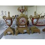 A late 19th century French gilt spelter clock garniture incorporating claret-ground porcelain