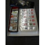Cigarette cards in plastic pages and a number of loose cards in a papier mache box. TO BID ON THIS