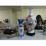 A large Oriental porcelain vase painted with fruiting and flowering peach stems, mark of