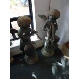 A pair of large metal garden figurines of Pan [hall] TO BID ON THIS LOT AND FOR VIEWING APPOINTMENTS