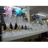 A shelf of good glassware including a suite of Stuart Crystal red wine, white wine, champagne