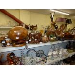 A shelf of wooden items including model ducks, fruit bowls, egg cups, dishes, elephants, African