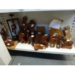 A shelf of 19 modern wood carvings by local artist Bernard Heyman [s4] TO BID ON THIS LOT AND FOR