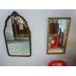 A small pretty wall mirror, the bevelled glass within a hardwood frame with shaped top and fan