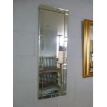 An elegant tall slim rectangular wall mirror with bevelled glass-tiled border (91.5 x 30.5 cm) TO