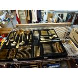 A German gilt steel cutlery service for 12, in two black trays, together with 12 Thai bronze soup