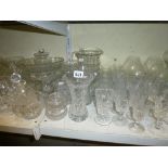 Two shelves of glassware including five decanters and stoppers, cut glass vase, Harlequin set of