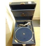 A portable wind-up gramophone by HMV in a blue fabric cover TO BID ON THIS LOT AND FOR VIEWING