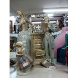 Three Lladro figurines comprising a large figure of a lady, another of a gentleman stood by an