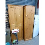 A pair of modern pine wardrobes each enclosed by a pair of panel doors. TO BID ON THIS LOT AND FOR