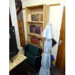 A modern pine-effect open bookcase of five shelves, two folding garden chairs, a garden parasol of