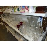 Two shelves of glassware including a set of 11 cut glass hock glasses, iridescent brandy balloons,