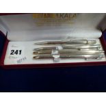 Four silver writing instruments, comprising: a Tiffany & Co ballpoint pen with T clip, a