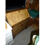 An early 18th century walnut bureau the cross-banded fall enclosing an interior of drawers and