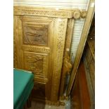 A spectacular light oak antique bed frame, possibly French, heavily carved the head with hat and