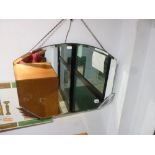 A 1950s bevelled oval wall mirror with chromed flash decoration (45 x 64 cm approximately) TO BID ON