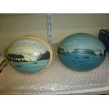 Two antique colonial souvenir painted ostrich eggs, each depicting ships off a shore with