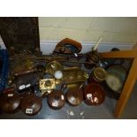 A quantity of vintage brass fireside implements, a brass tray, two 19th century irons, a brass